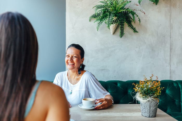 Two women talking over coffee in a coffee shop