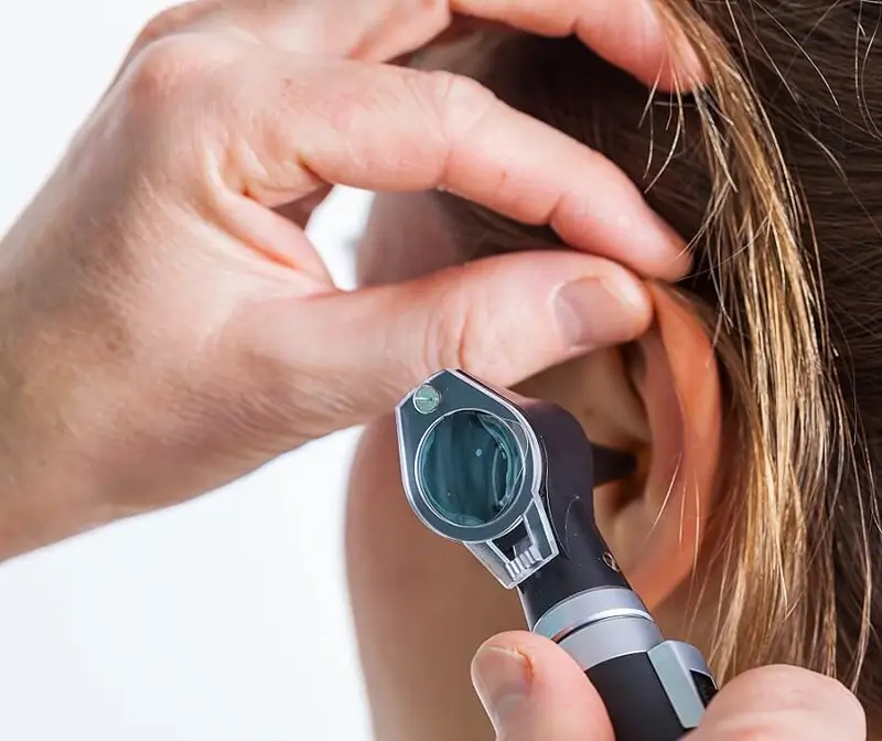 woman receives a hearing test from audiologist